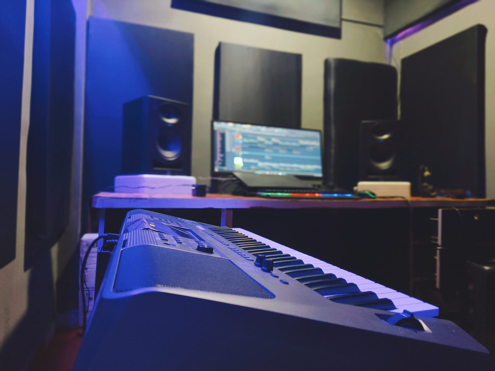 Keyboard and studio monitor setup inside Neone Wave Production